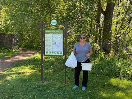 Trail Adopter picking up litter on the River Pines Trail